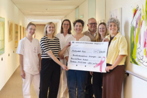 Madeleine Back, Dr. Sonja Pfeifer, Ute Berthel, Kerstin Barthel, Dr. Andreas Cramer, Nicole Götz und Sina Müller posieren bei einer Spendenübergabe mit einem großen Scheck über 500 Euro.